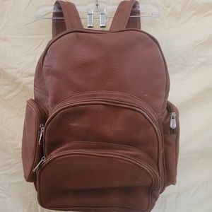 Leather Backpack expandable back. Adjustable Leather shoulder straps, six zipper